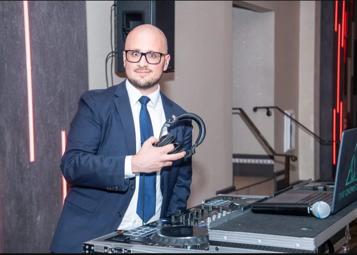 MAHIG in a blue suit at a wedding celebration